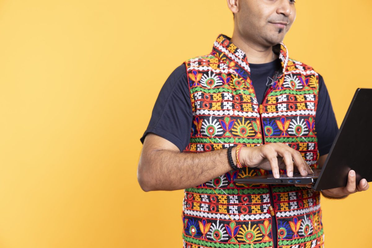 Worker typing on laptop, doing business related tasks, isolated over studio backdrop. Close up shot of person doing budgeting, forecasting, and financial analysis on notebook